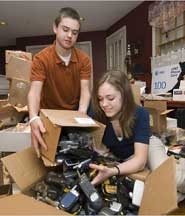 Robbie and Brittany Bergquist of Norwell, Mass., sorting used cellphones they will sell to a recycler.
