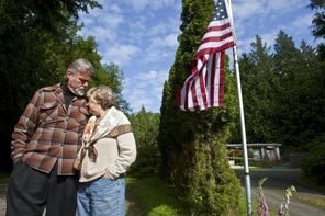 Perry McClellan and Judith Gorman put a flagpole in front of their home to commemorate their son's life and service - Photo: Dean Rutz, the Seattle Times