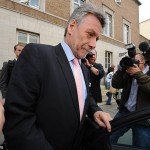Neil Wallis leaving police station