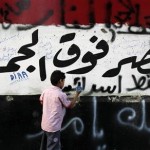 A boy knocks down a concrete wall built in front of the Israeli embassy in Cairo September 9 2011. The message on the wall reads, Egypt is over all and Down Israel.