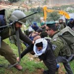 Palestinian protester scuffles with Israeli border police officers during a demonstration against Israel’s separation barrier in the West Bank village of Beit Jalla, near Bethlehem. Wednesday, March 3, 2010.