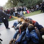 California, Davis Police Lt. John Pike uses pepper spray to move seated Occupy UC Davis protesters while blocking their exit from the school’s quad in Davis, Calif.