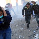 Tahrir2 Protesters flee tear gas in Tahrir Squaire on Monday