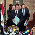 Egyptian investigative judges Sameh Abu Zeid, right, and Ashraf el-Ashmawi, who are investigating the foreign funding of NGOs, enter a press conference at the Justice Ministry in Cairo on Feb. 8, 2012