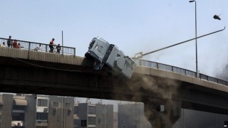 Armoured police vehicle pushed off a bridge near Ramses, downtown Cairo, by violent MB mob.