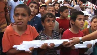 Hired orphans herded in a MB sit-in carrying their coffin wrappings as potential suiciders