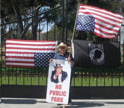 Rees Lloyd, former Commander of District 21 and “legal advisor” to the American Legion holds an upside down American Flag in front of the Los Angeles VA during a past protest rally.