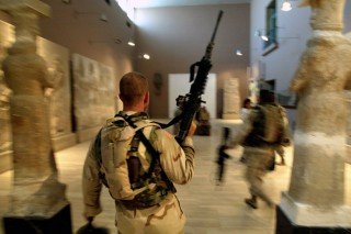 Two US soldiers from the 1st Division, 2nd Bridage, Texas, storming & looting the Iraq Museum 10 September 2003 in Baghdad