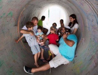 Israelis shelter in a pipe during an attack from Gaza
