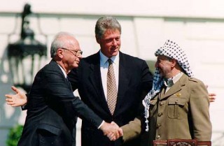 Yitzhak Rabin and Yasser Arafat shake hands after signing Oslo Accords , working for peace and land transfer