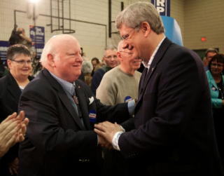 Senator Mike Duffy and Prime Minister Mike Duffy in Happier Times. CTV reporter was elevated to the Senate for violating his journalistic objectivity by openly campaigning for Harper While He Was Still a Journalist. Now Duffy is Charged with Accepting a Bribe from the Prime Ministers Office. The War on ISIL is helping Harper change the subject of political discourse in Canada.