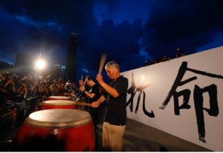 Founders of the Occupy Central civil disobedience movement, Rev Chu Yiu-Ming, Benny Tai and Chan Kin-man, play drums