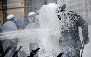 Protesters spray milk at peacekeepers
