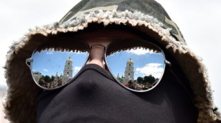 The Saint Sophia cathedral is reflected in the glasses of a new volunteer recruit of the Ukrainian army ‘Azov’ battalion, after a military oath ceremony in Kiev and before his contingent heads to eastern regions, June 23, 2014