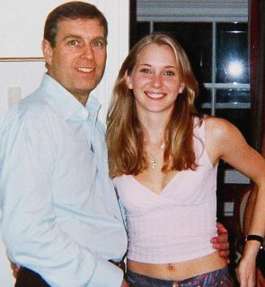 An underage Virginia Roberts photographed with Prince Andrew in early 2001 (file photo)