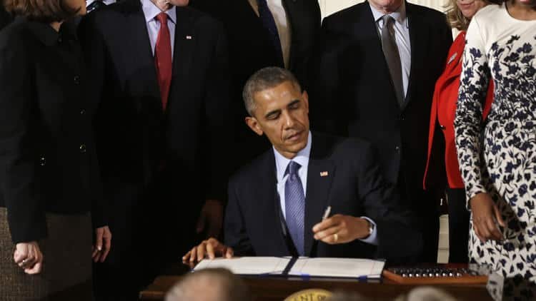 President Barack Obama signs the Clay Hunt Suicide Prevention for American Veterans Act, named for Clay Hunt, which calls for evaluation of existing Veterans Affairs mental health and suicide prevention programs and expands the reach of these programs for veterans, Thursday, Feb. 12, 2015, at... (Jacquelyn Martin / Associated Press)