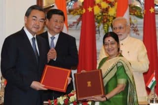 Prime Minister, Shri Narendra Modi and Chinese President Xi Jinping witnessing the signing of an MoU between the Ministry of External Affairs Minister, Smt. Sushma Swaraj and Minister of Foreign Affairs of the PRC, Wang Yi on opening a new route for Indian -pilgrimage to the Tibet Autonomous Region of the People's Republic of China