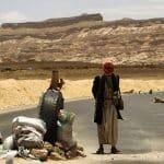 Armed tribal militants man a checkpoint on a road linking the Yemeni capital Sanaa with the oil-rich province of Marib
