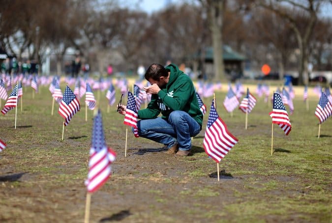 A Navy veteran, Jeff Hensley, set up flags in Washington in March for veterans and service members who had committed suicide. Credit Jewel Samad/Agence France-Presse — Getty Images 