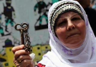Palestinian woman with key to her family's old house