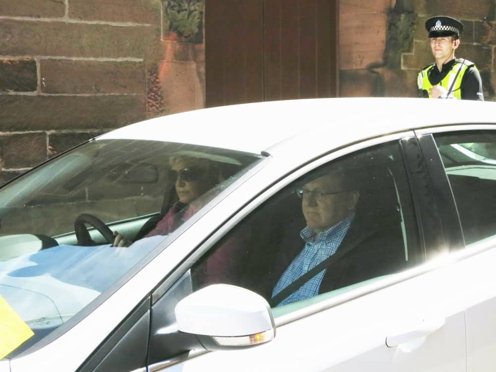 Minister of the Crown 'Fluffy' Mundell makes his escape from the back door into a waiting car.