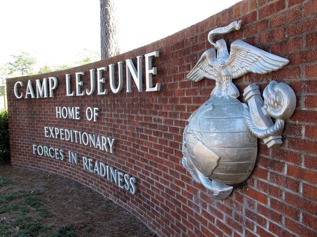 FILE - This March 19, 2013 photo shows the globe and anchor stand at the entrance to Camp Lejeune, N.C. An explosion that killed seven Camp Lejeune Marines during a nighttime training exercise on March 18, 2013, was the result of human error and insufficient training, according to the results of a military investigation. Lt. Adam Flores, a spokesman for the Lejeune-based 2nd Marine Division, said Wednesday, Jan. 22, 2014 that the investigation found the deadly March 18 explosion was triggered when a Marine dropped a second round into an already loaded mortar tube during a live-fire exercise. Two officers and a noncommissioned officer were relieved of command following the explosion at Hawthorne Army Depot in Nevada.  (AP Photo/Allen Breed, File)