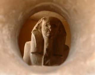 This solemn looking III Dynasty statue of King Djsoer peers out of one of the two peepholes to the Circumpolar stars