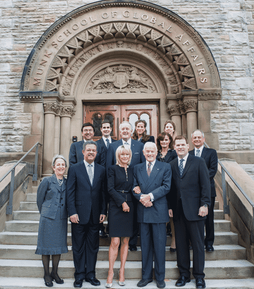 Some Prominent Canadian Members of Barrick's Barricudas Pose in Front of the Entrance Way to the Munk School of Global Affairs at the University of Toronto.. Cozying up to Peter Munk on His Left is Then Foreign Affairs Minister John Baird. Baird Tried to Defend Nigel Wright in 2012 When the PM's Chief of Staff Stood Accused of Exploiting His Access to Harper to Advance Barrick's Interests. In 2015 Baird Would Hand Over $9 million in Public Funds to the Munk School Before Joining Barrick's International Advisory Board. The Current Chair of That Board is Brian Mulroney Pictured in the Centre. Flanking Mulroney is Former U of T President, David Naylor, Now a Member of the Board of Barrick Gold, and the Current U of T President Meric S. Gertler.