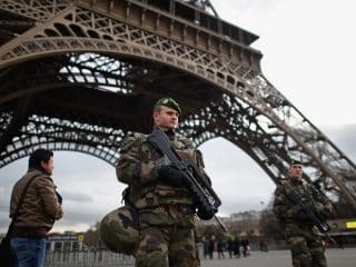 PARIS, FRANCE - JANUARY 12: French troops patrol around the Eifel Tower on January 12, 2015 in Paris, France. France is set to deploy 10,000 troops to boost security following last week's deadly attacks while also mobilizing thousands of police to patrol Jewish schools and synagogues. (Photo by Jeff J Mitchell/Getty Images) *** BESTPIX ***