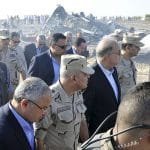 Egypt’s Prime Minister Sherif Ismail (C) and Egypt’s Defense Minister Sedki Sobhi (2nd L) walk at the site where a Russian airliner crashed in central Sinai near El Arish city