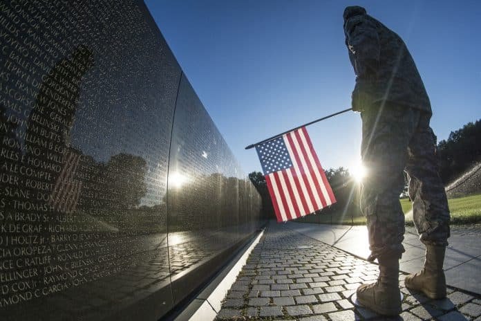 Soldier at the Vietnam Memorial wall